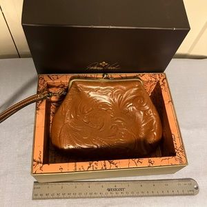 Patricia Nash Metal closure clutch with wrist leash.  Embossed genuine Leathers